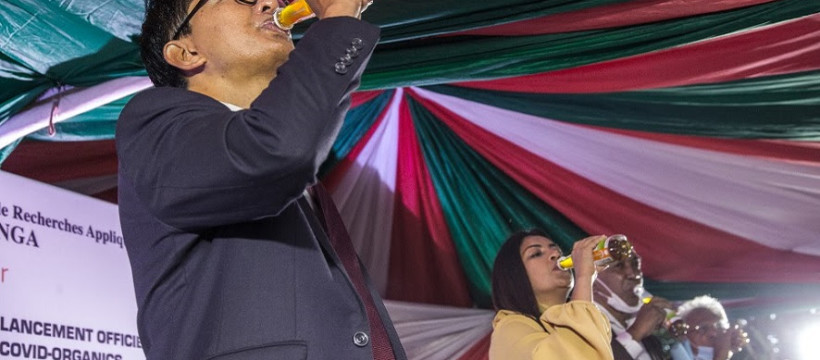 Madagascar's President Andry Rajoelina drinks a sample of the "Covid Organics" or CVO remedy at a launch ceremony in Antananarivo on April 20, 2020. "Covid Organics" or CVO is a remedy produced by the Malagasy Institute of Applied Research (IMRA) created from the Artemisia plant and supposedly help to prevent any infection caused by the new coronavirus Covid-19. (Photo by RIJASOLO / AFP)