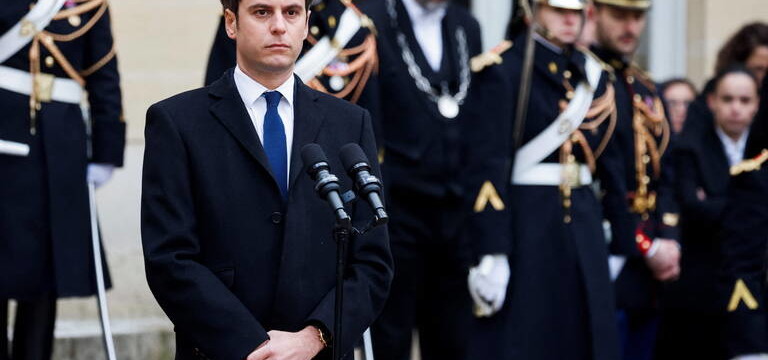 Newly appointed Prime minister Gabriel Attal listens to the speech of outgoing Prime minister Elisabeth Borne during the handover ceremony at the Hotel Matignon in Paris, on January 9, 2024. Gabriel Attal, named France's youngest ever prime minister on January 9 at the age of 34, has had a meteoric rise that has invoked comparisons with that of his mentor President Emmanuel Macron. (Photo by Ludovic MARIN / POOL / AFP)