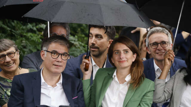 French Socialist Party (PS) first Secretary Olivier Faure (L) and National Secretary for The Ecologists formely known as Europe-Ecologie-Les Verts (EELV) Marine Tondelier (R) look on during an open-air legislative election campaign meeting "Building the Popular Front (NFP) with civil society" of the electoral coalition of left-wing parties dubbed the "Nouveau Front Populaire" (New Popular Front) at Place Jean-Jaures in Montreuil on June 17, 2024. (Photo by Ludovic MARIN / AFP)