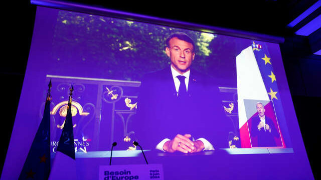 French President Emmanuel Macron appears on a screen following results after the polls closed in the European Parliament elections, in Paris, France, June 9, 2024. REUTERS/Abdul Saboor - RC2U78A12451