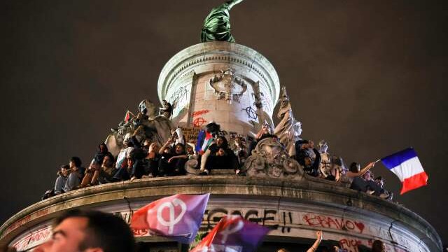 Participants gather during an election night rally following the first results of the second round of France's legislative election at Place de la Republique in Paris on July 7, 2024. A loose alliance of French left-wing parties thrown together for snap elections was on course to become the biggest parliamentary bloc and beat the far right, according to shock projected results. (Photo by EMMANUEL DUNAND / AFP)